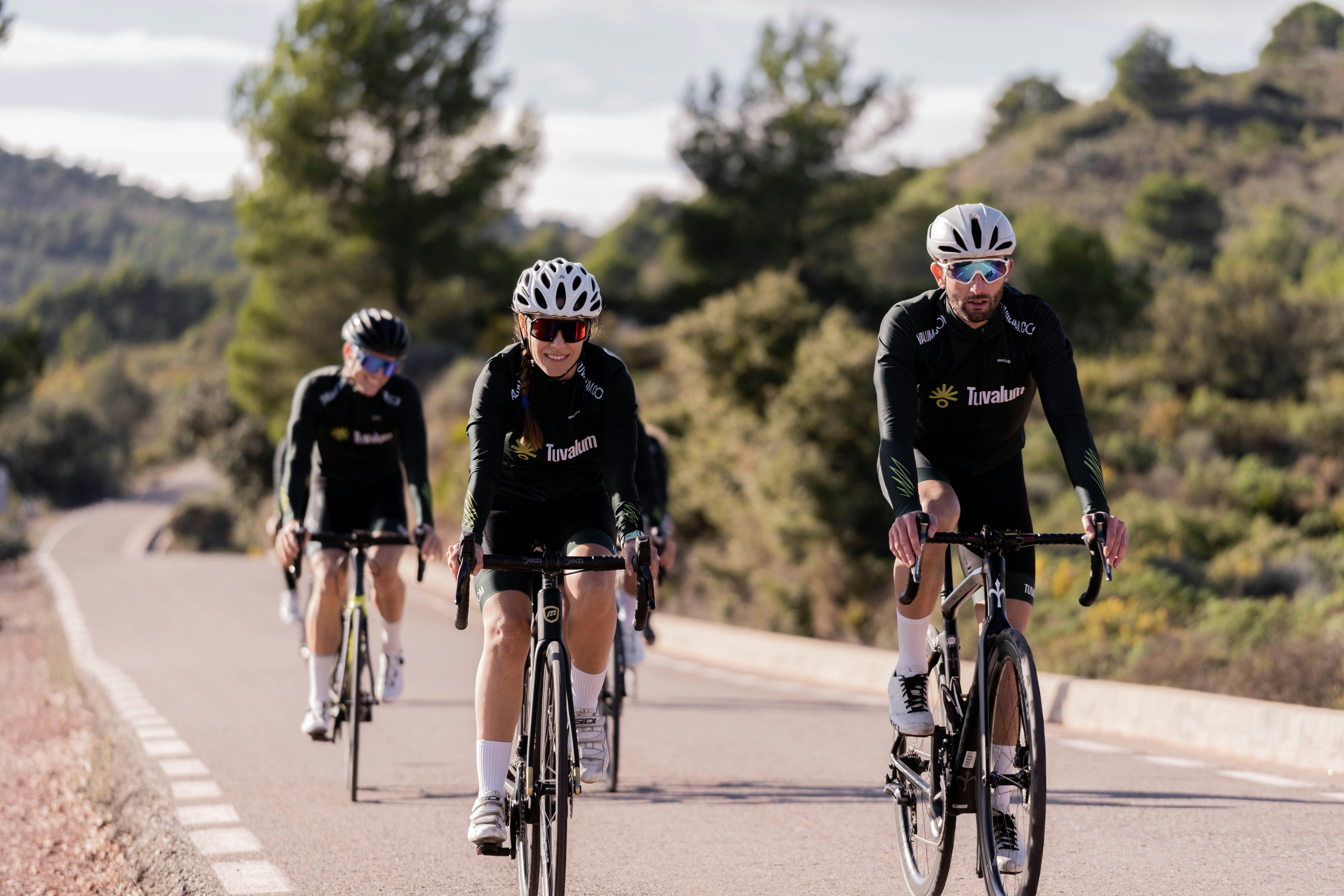 a group of people riding bikes on a road