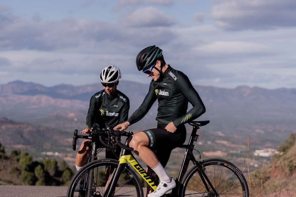 two men riding bikes