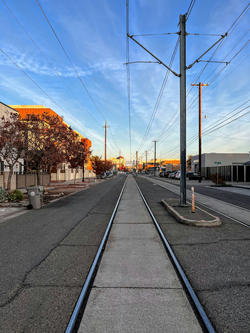 train tracks with power lines above them