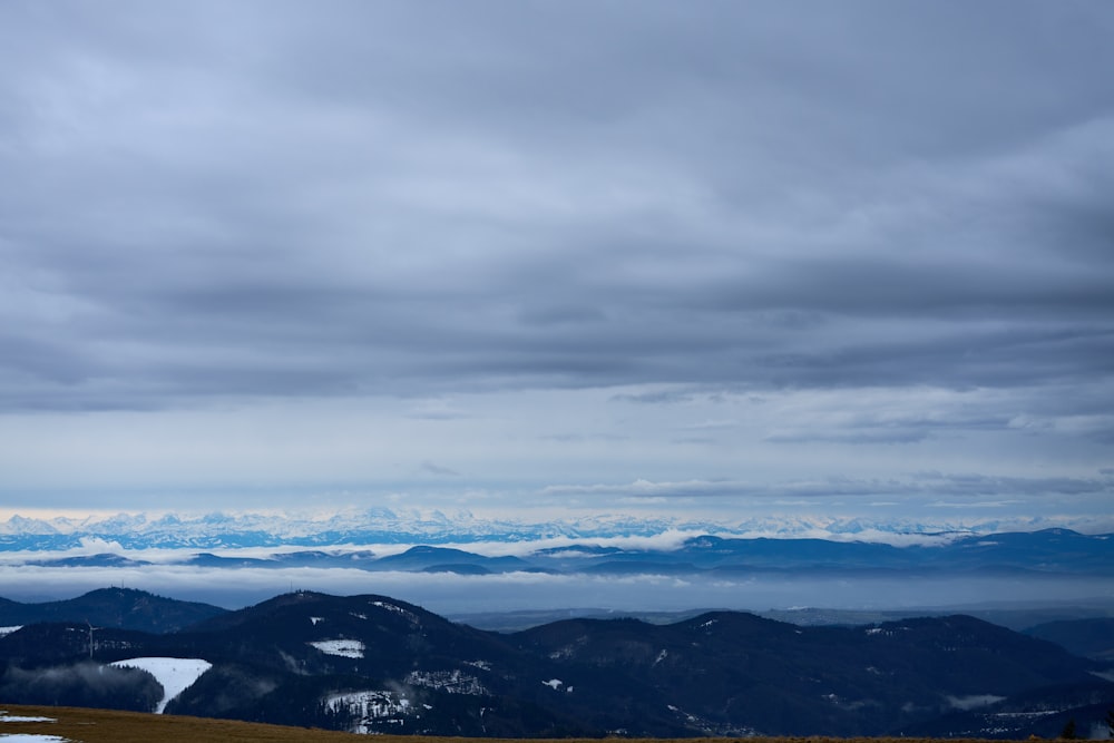 a landscape with mountains and clouds