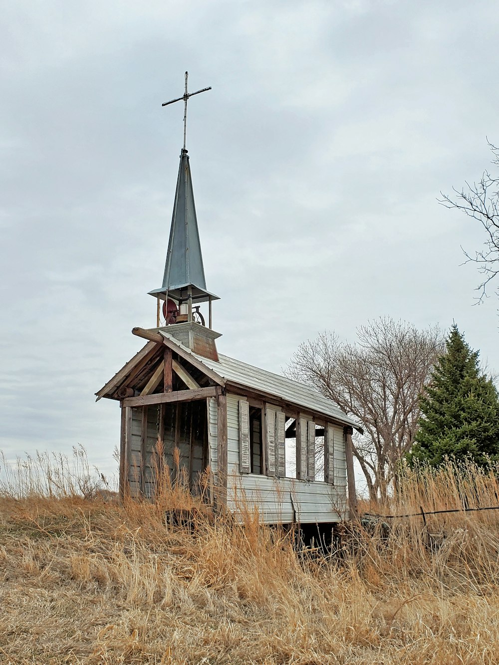 a small wooden building with a steeple