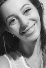 Close-up of a refined escort smiling warmly in a luxurious London setting.