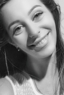 A captivating shot of an escort smiling warmly, with clear details of her offerings and prices below.