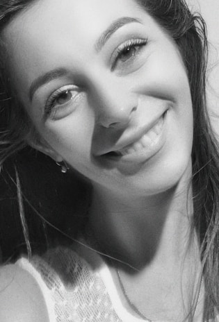 Portrait of a young woman smiling confidently after her rehabilitation journey.