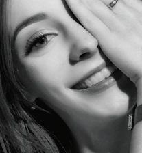 Close-up image of Ania smiling energetically, showcasing her vibrant online presence.