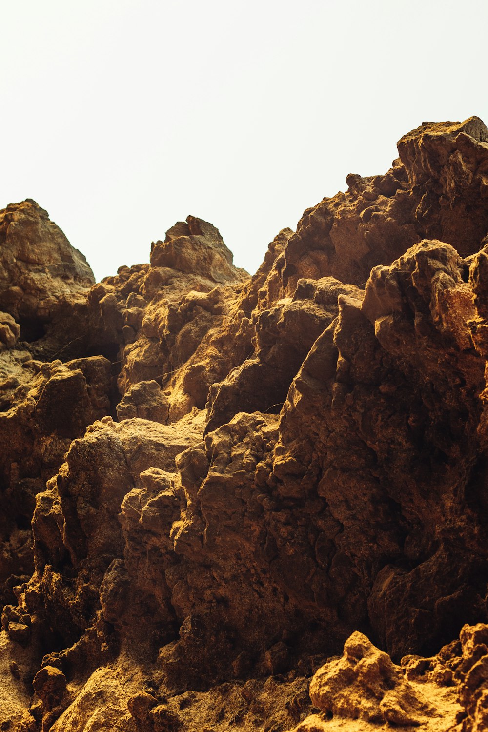 a rocky cliff with a blue sky