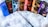 A collection of seven books from the Harry Potter series is displayed on a fluffy white surface. Each book has a colorful and distinct cover design. A wand is placed in front of the books, creating a magical theme.
