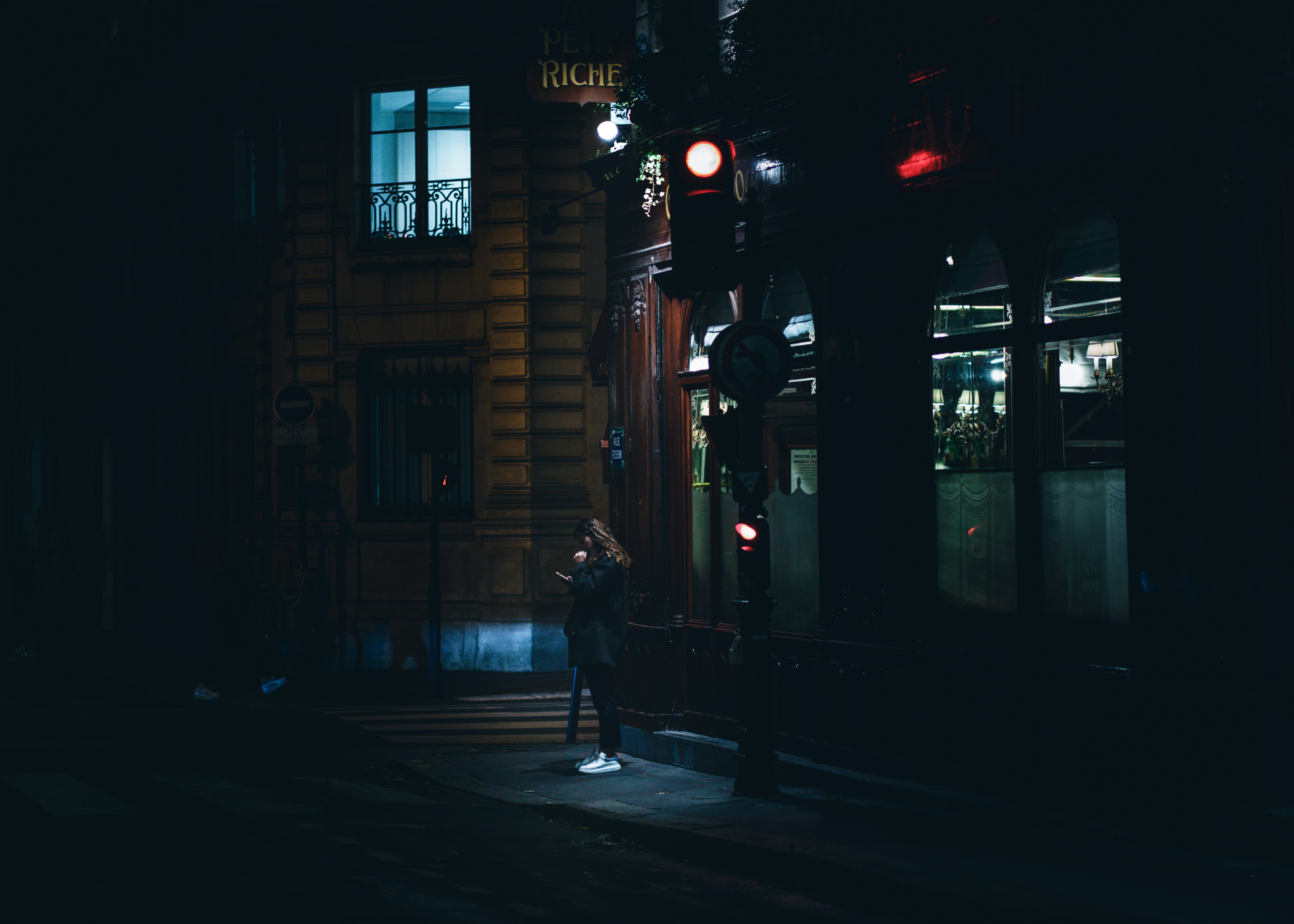 a person stands on the sidewalk