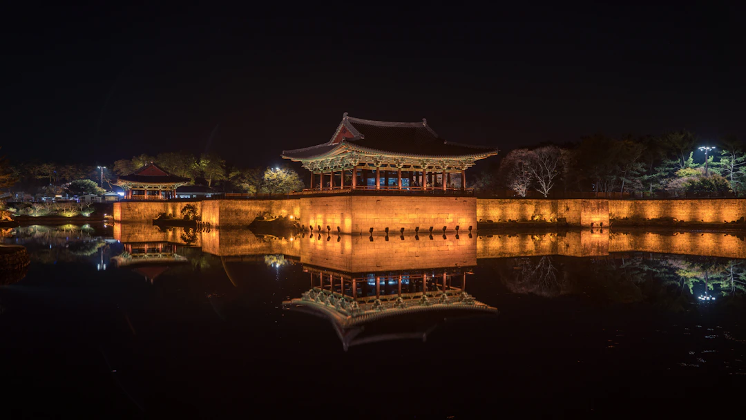 Illuminated pavilion at Donggung Palace reflected in Wolji Pond at night