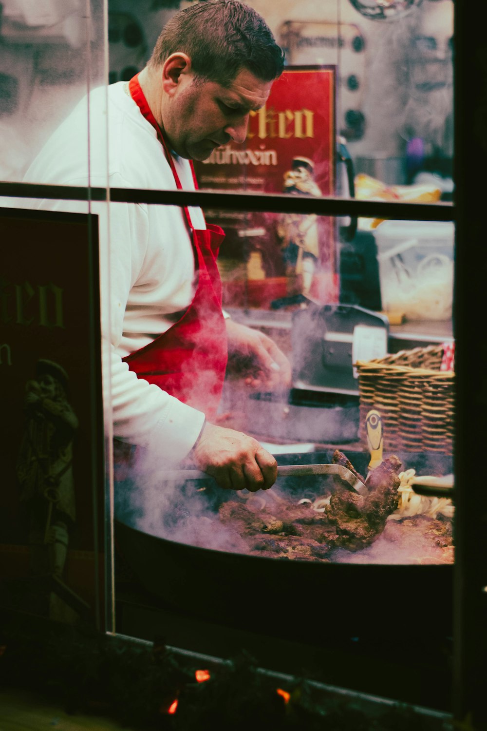 a man cooking food in a restaurant