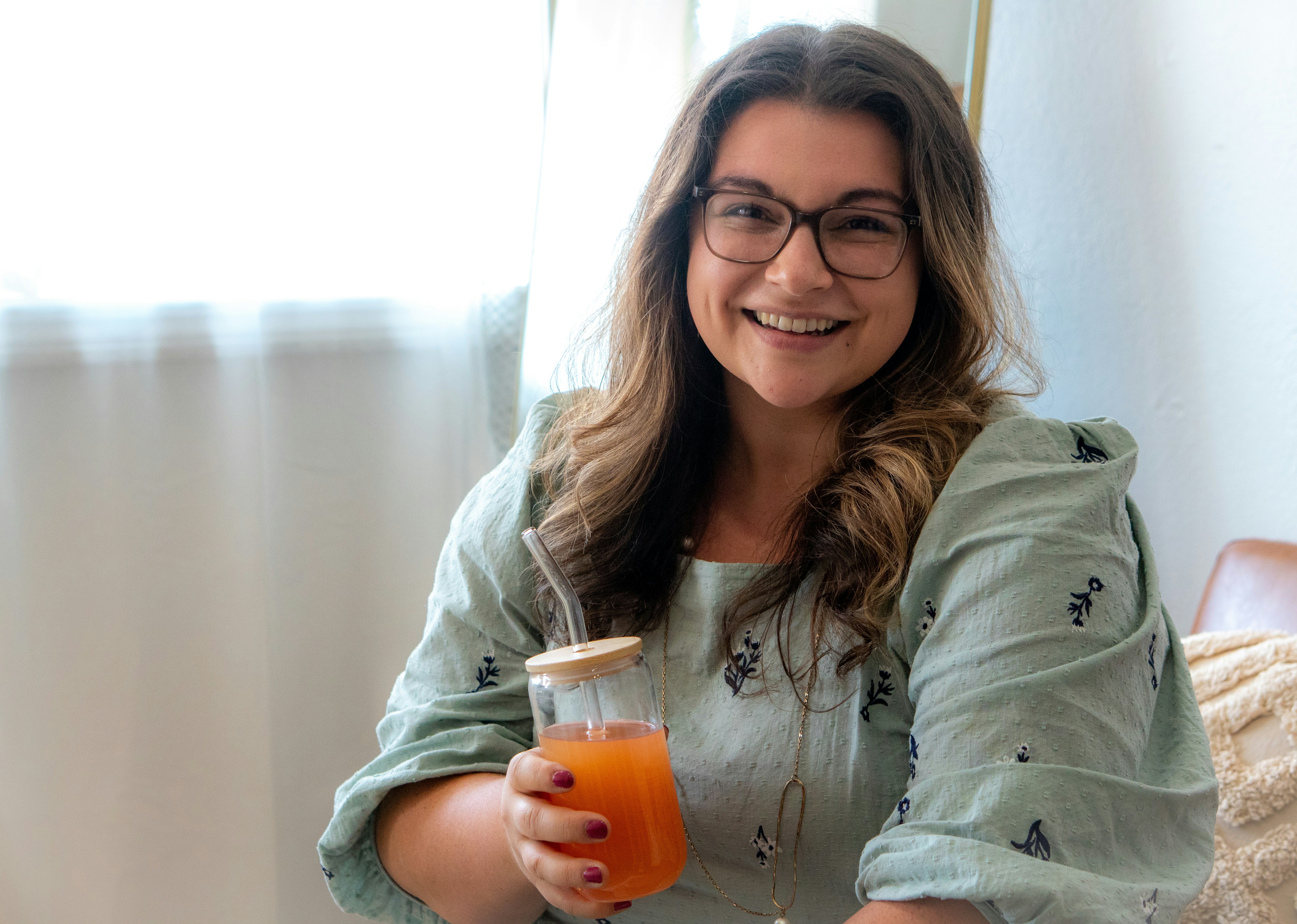 a woman holding a glass of beer