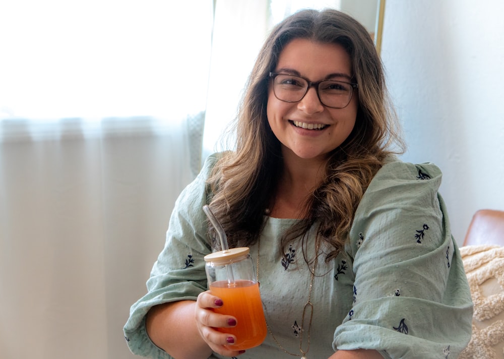 a woman holding a glass of beer