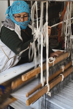 a person wearing a mask and working on a piece of wood