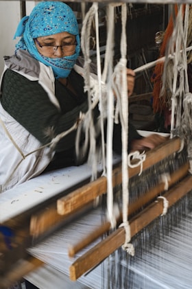 a person wearing a mask and working on a piece of wood