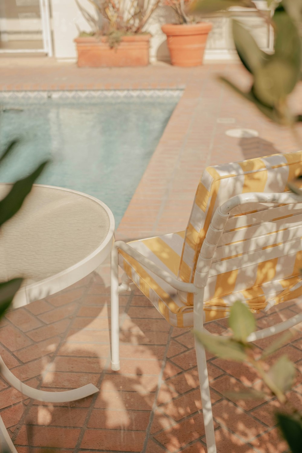 a table with a chair and a plant on it