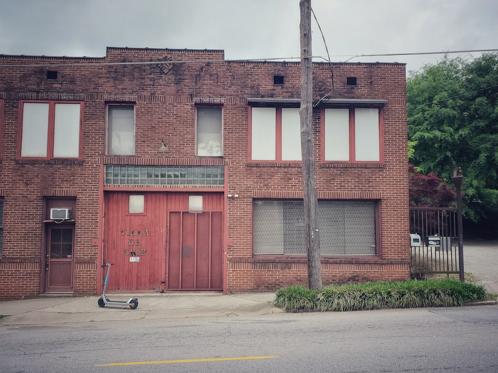 a brick building with a metal pole in front of it with Surratt House Museum in the background