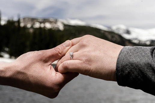 Close-up of hands shaking over a signed real estate contract with a scenic view