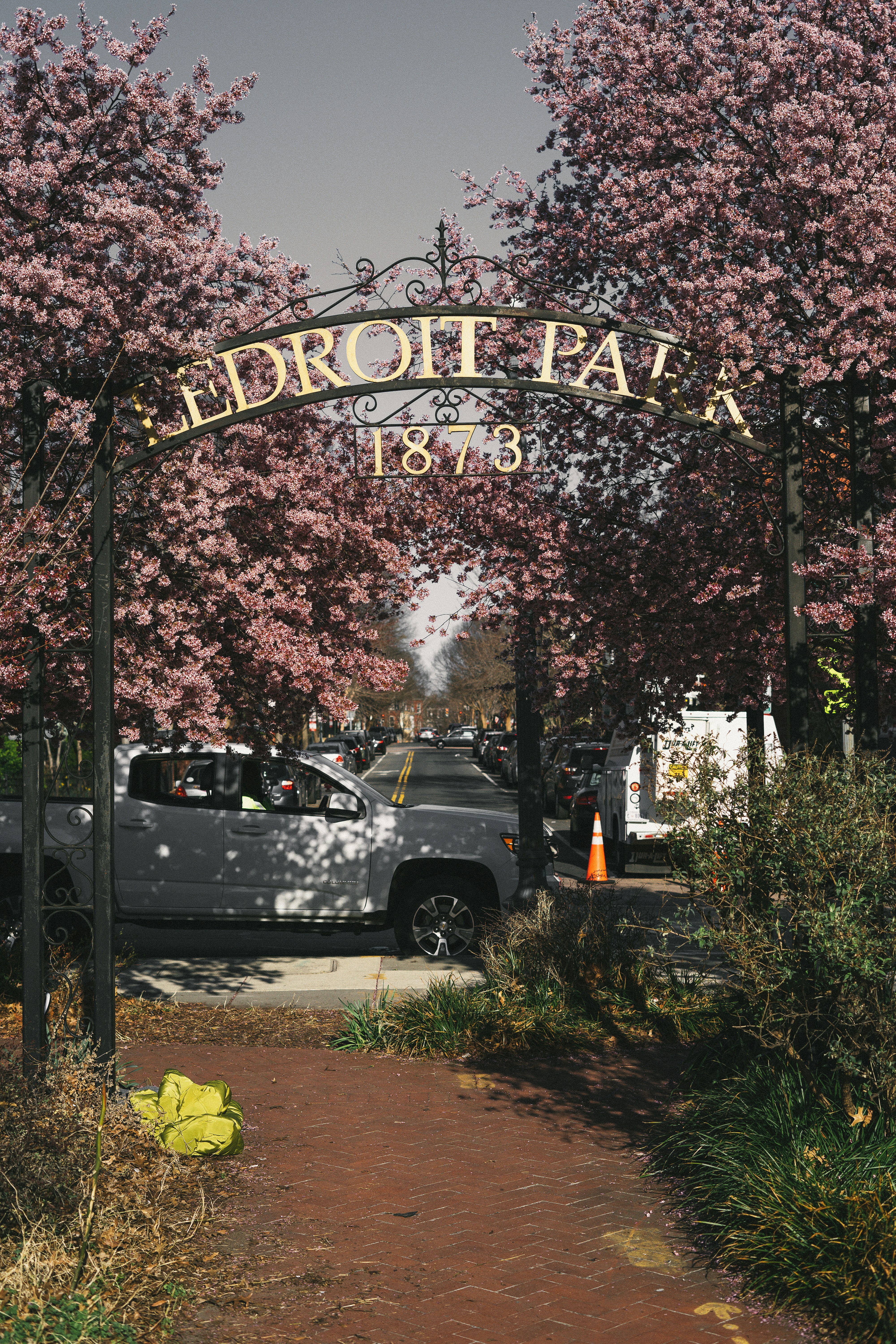 a sign with a car in the background