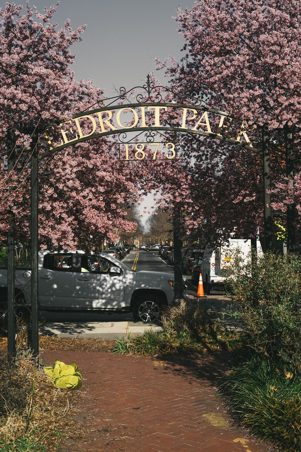 a sign with a car in the background