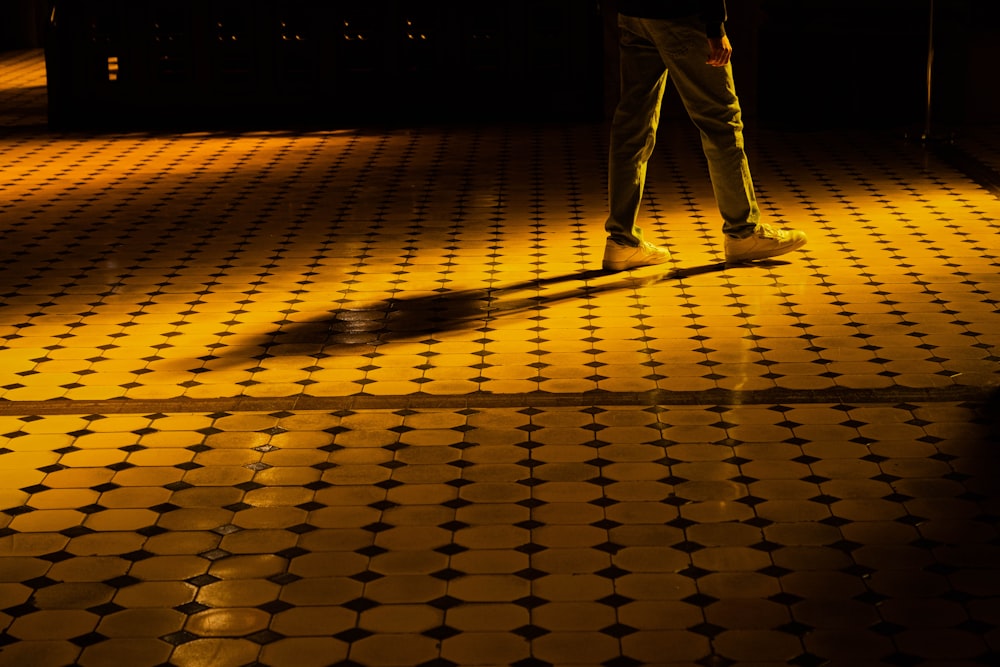 a person walking on a tiled floor