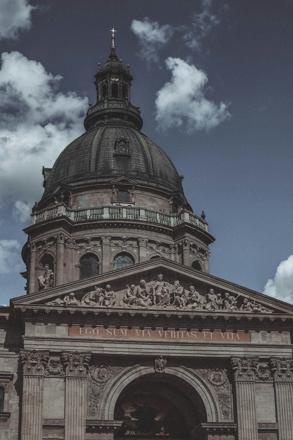 a large building with a domed roof with Texas State Capitol in the background