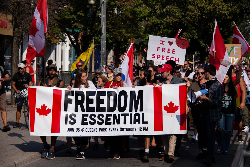 a group of people holding signs and flags