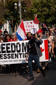 A close-up of a protest sign reading 'Freedom of Speech, Not Hate'.
