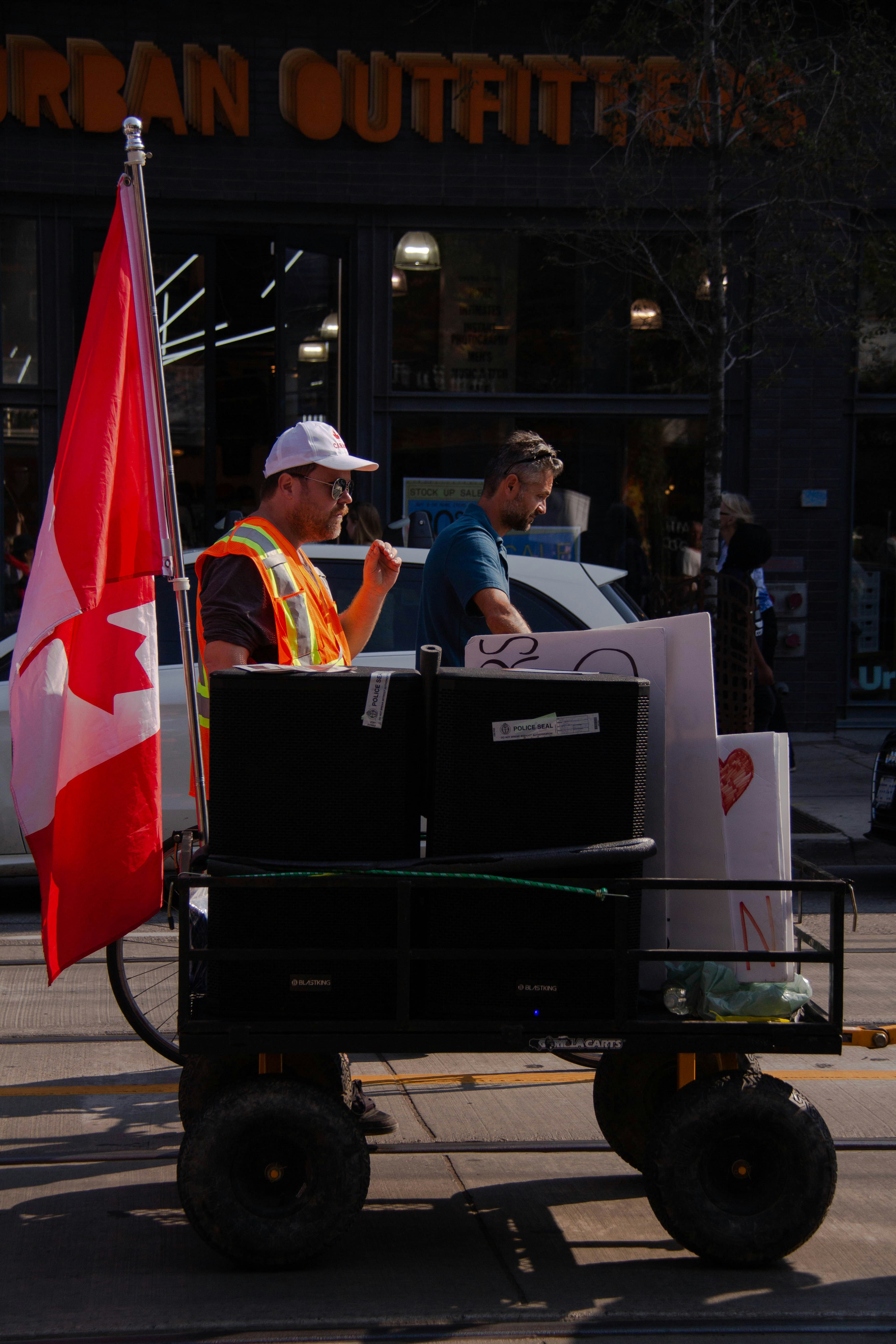 a couple of men in a cart with a flag