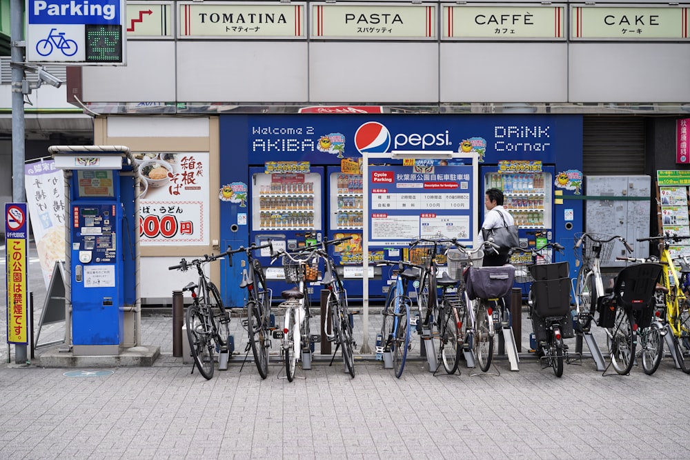 a person standing next to a row of bicycles