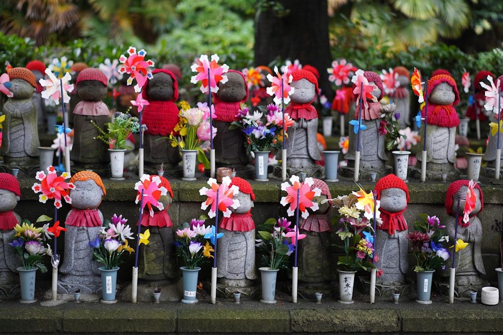 a group of statues with flowers