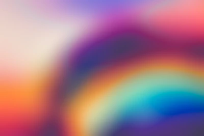 Vibrant abstract rainbow colors blending softly on a dark background.