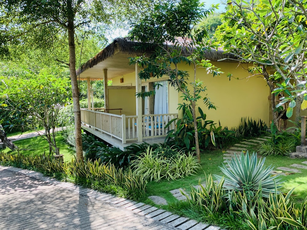 a yellow house with a deck