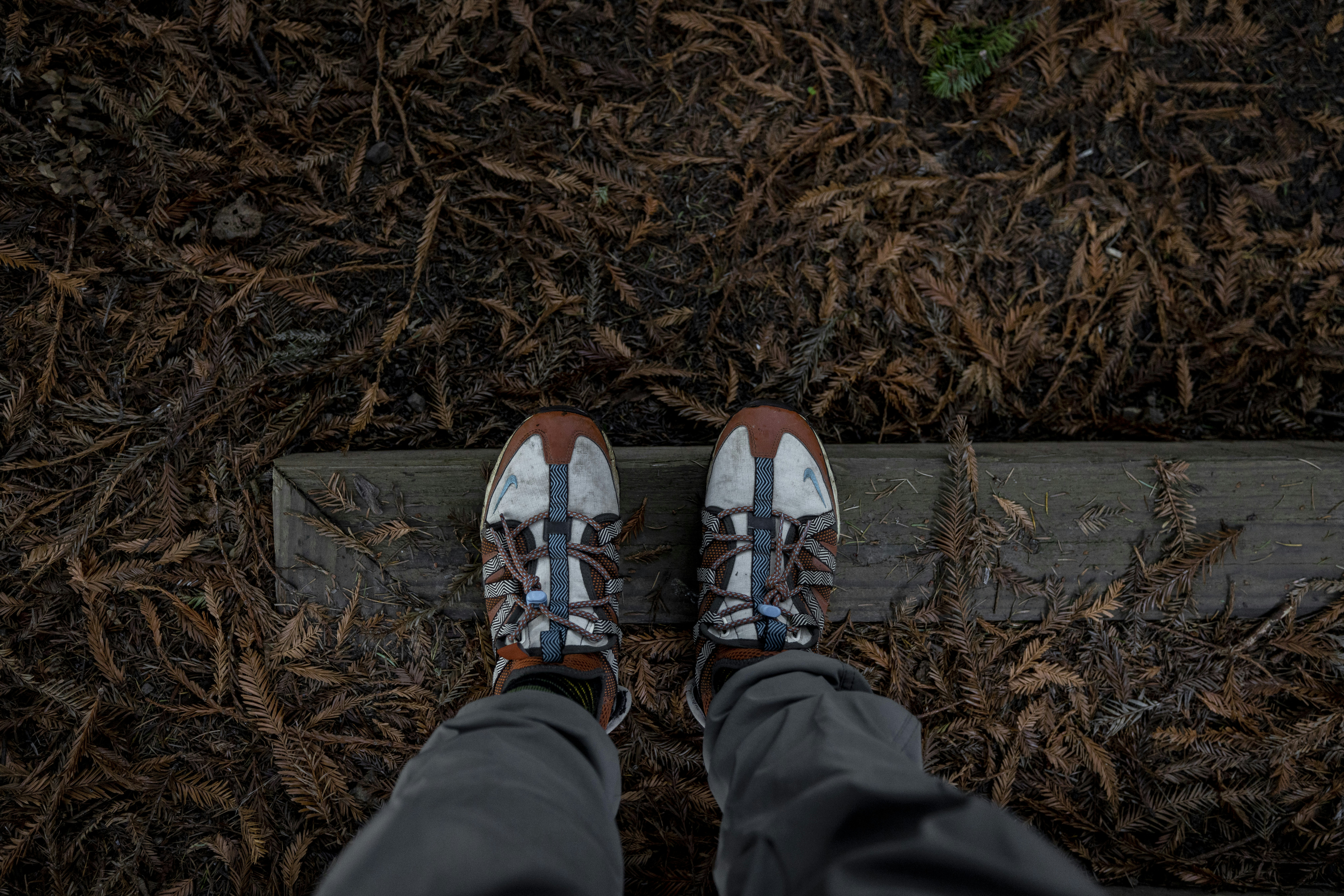 a person's feet on a concrete ledge
