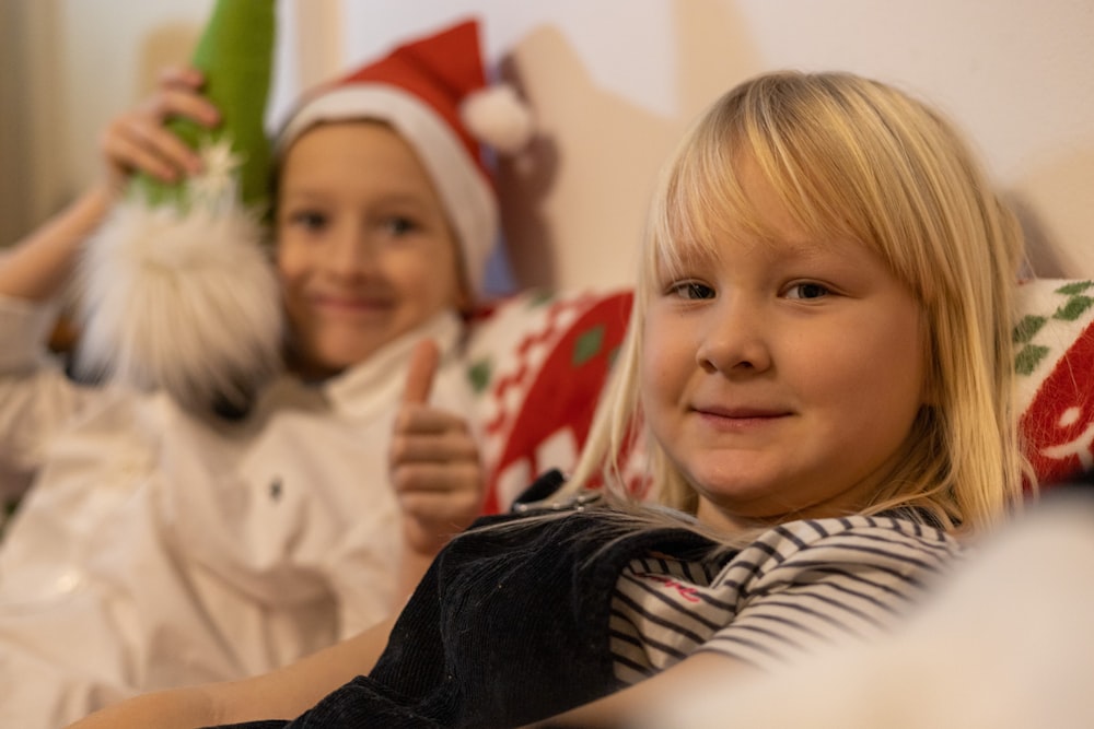 a couple of girls wearing santa hats