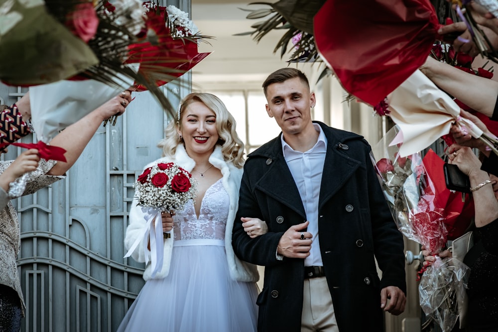 a man and woman holding flowers