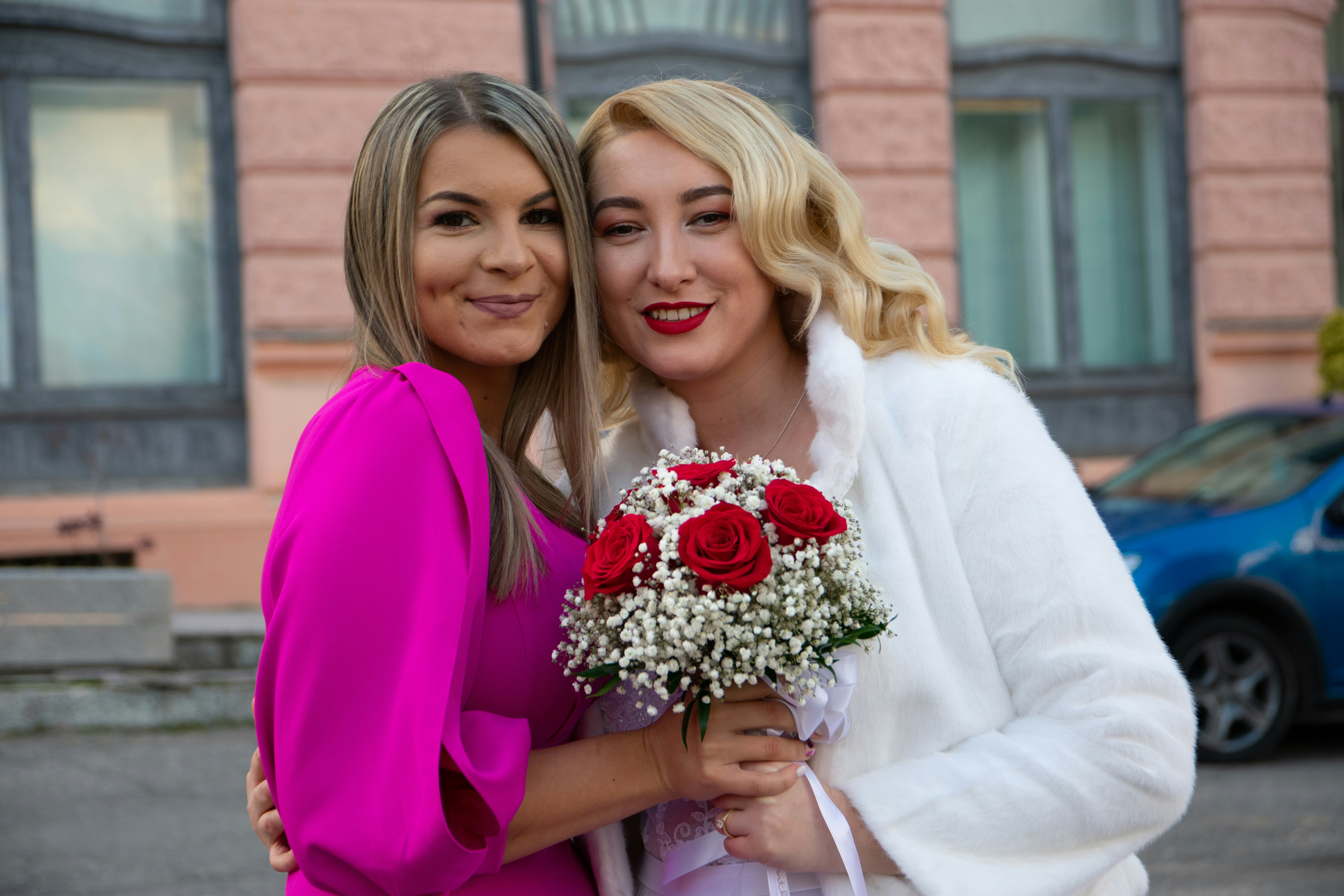 a couple of women holding flowers