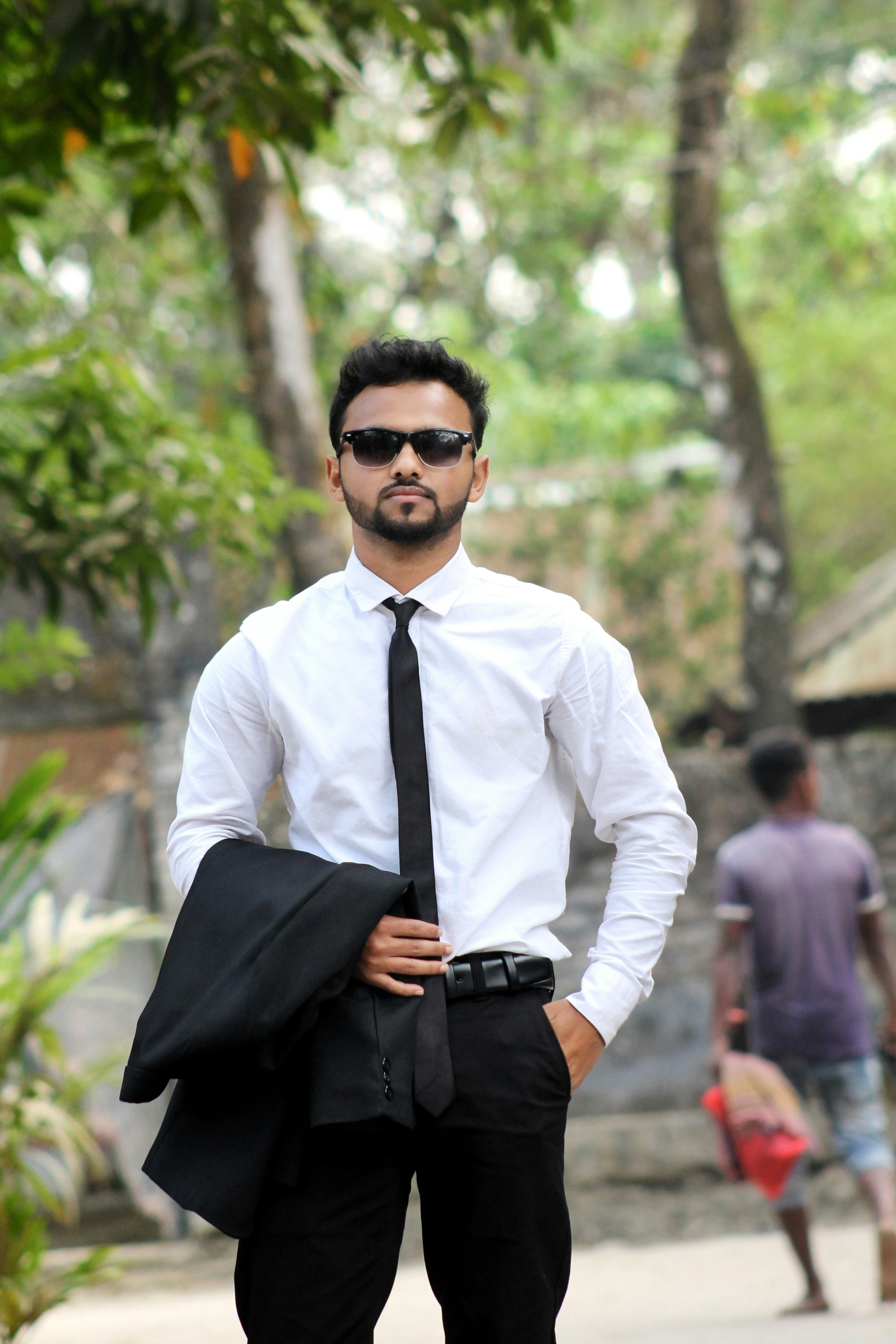 a man in a tie and sunglasses