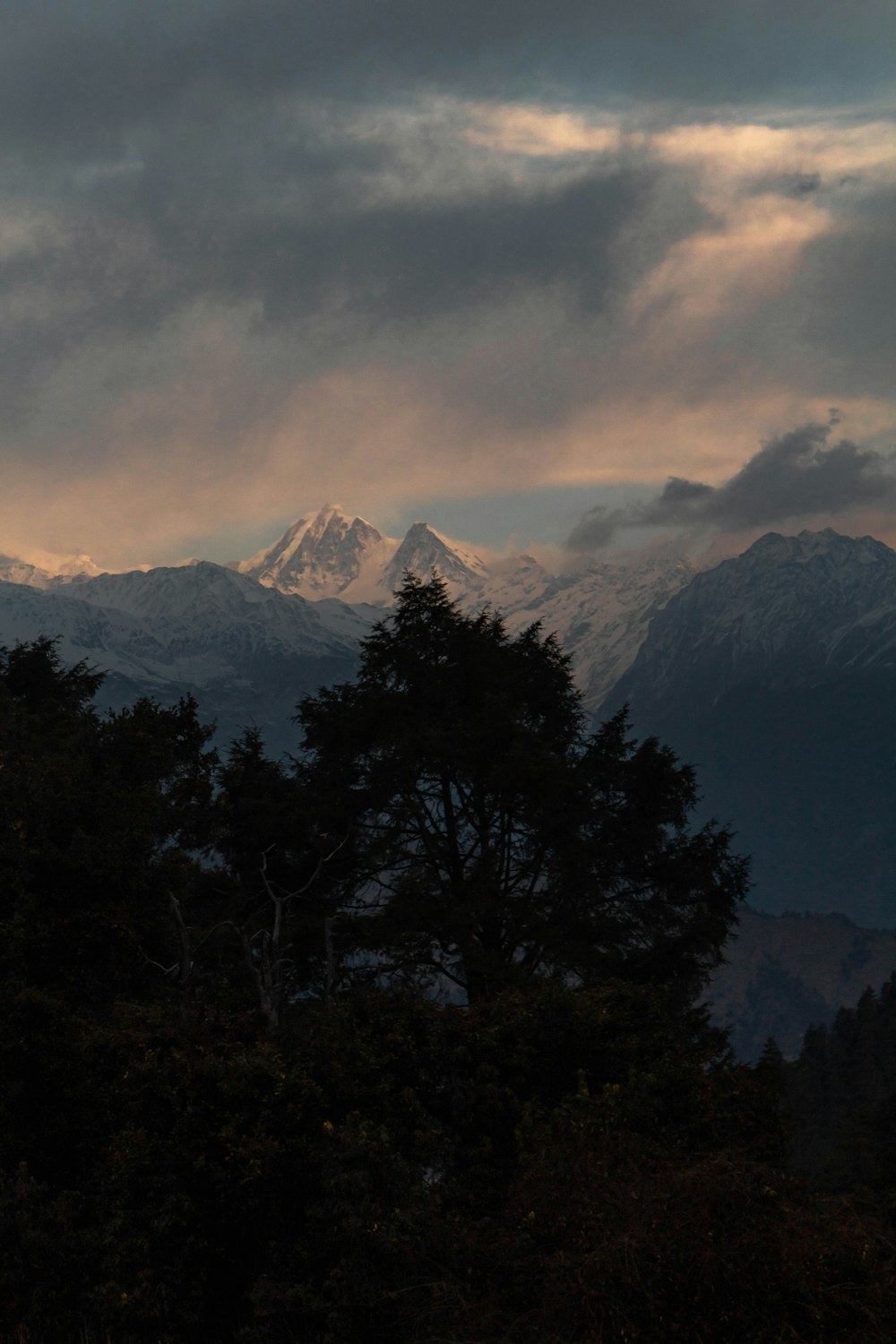 a mountain range with clouds