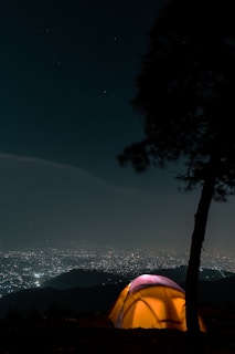 Close-up of glowing disco tent exterior against the night sky with subtle monochromatic color scheme