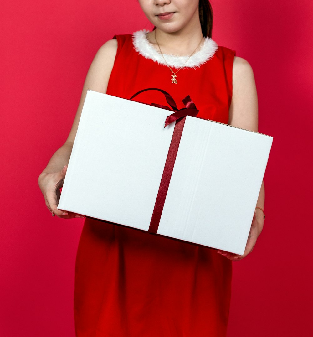 a woman holding a white box