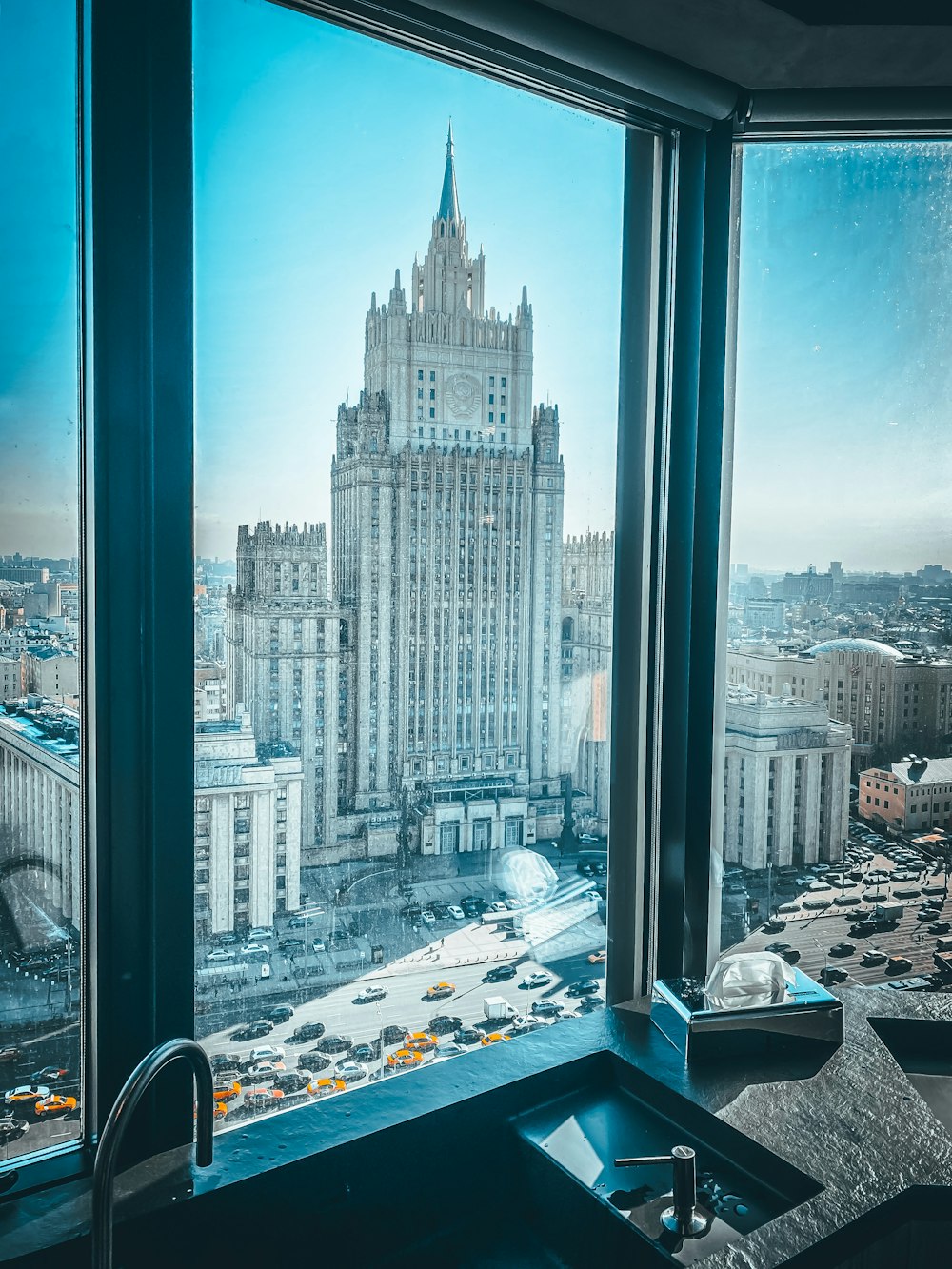 a tall building with a city in the background