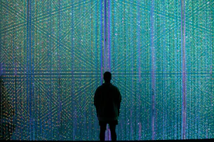 a person standing in front of a wall of lights