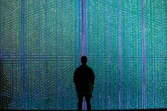 a person standing in front of a wall of lights