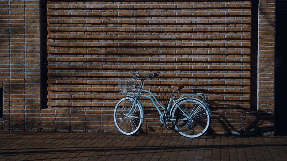 a bicycle parked against a wall