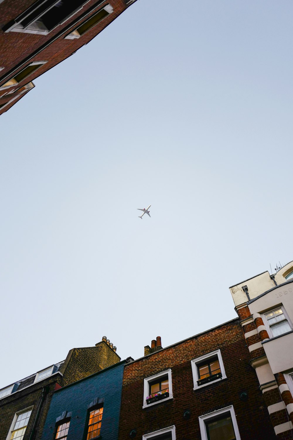 a plane flying over buildings