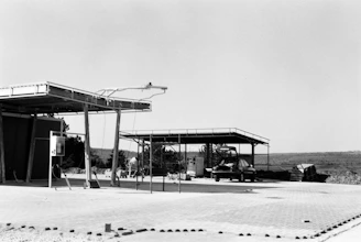 Bauhaus-inspired black and white photo of a sleek modern gas station exterior.