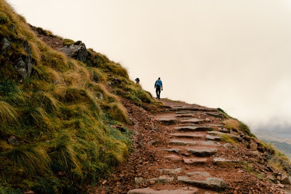 Hiker on a foggy mountain path in the Scottish Highlands