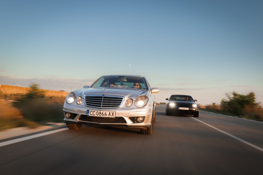 two cars driving on a road