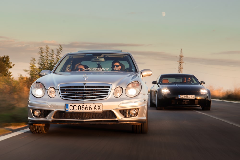 two cars driving on a road