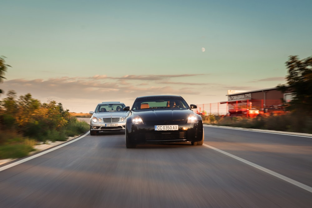 two cars driving on a road